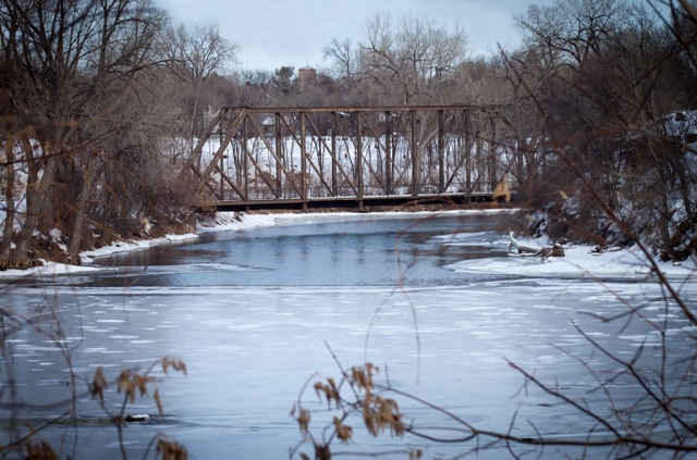 Train bridge over frozen river in Minneapolis, MN